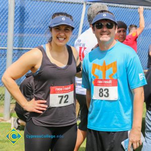 Man and woman in athletic wear with race numbers