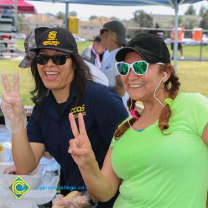 Two women holding up peace signs