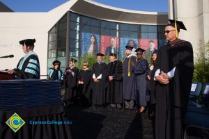 Faculty and staff onstage at commencement