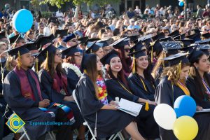 Students in the commencement audience smile