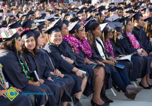 Students smile in the audience at commencement