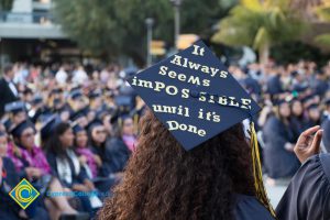 A graduation cap reads "It always seems impossible until it's done"