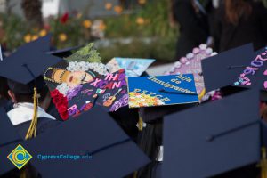 Graduation caps read "Hija de inmigrantes" and "This Xicana is Psyched"