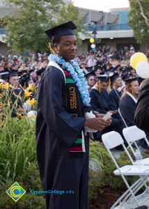 A graduate smiles at commencement