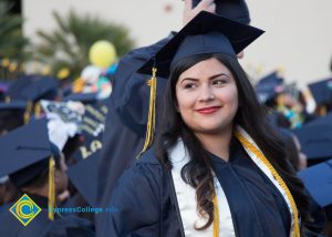 A graduate smiles at commencement