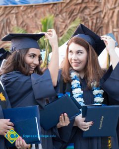 Graduates move their tassels during commencement