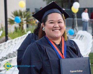 A student smiles at commencement