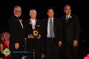 President Bob Simpson with three gentlemen in suits and tie at the 40th Annual Americana Awards.