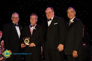 President Bob Simpson with three gentlemen in suits and tie at the 40th Annual Americana Awards.