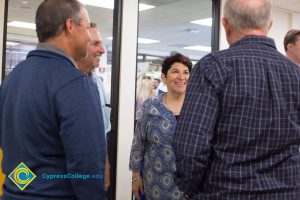 Carmen Dominguez speaking to three gentlemen.