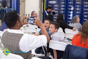 A man taking a photo of two young boys.