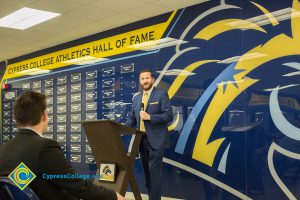 Rick Rams holding a microphone and smiling.