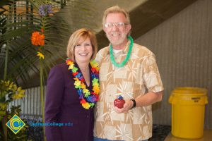 Dr. JoAnna Schilling with male employee at end-of-the-year luau