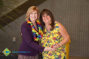 JoAnna Schilling with female employee at end-of-the-year luau