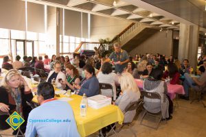 Employees gathered at tables at end-of-the-year luau