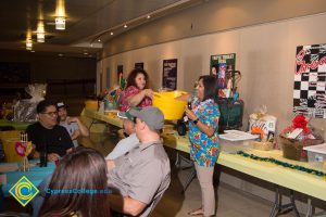 Ruth Gutierrez and Melissa Barrios calling raffle numbers at end-of-the-year luau