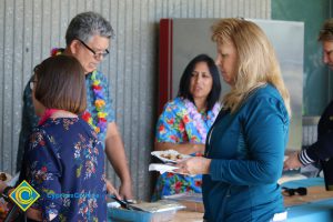 Employees getting food at end-of-the-year luau