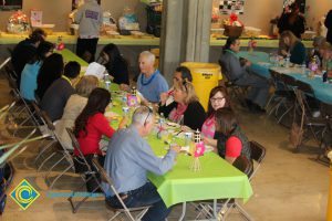 Employees gathered at tables at end-of-the-year luau