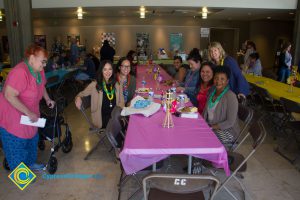 Employees sitting at table at end-of-the-year luau