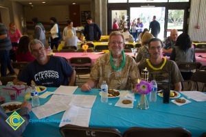 Maintenance & Operations employees sitting at table at end-of-the-year luau