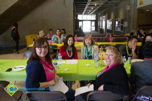 Employees sitting at table at end-of-the-year luau