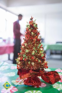 Small red tinsel Christmas tree on a table.