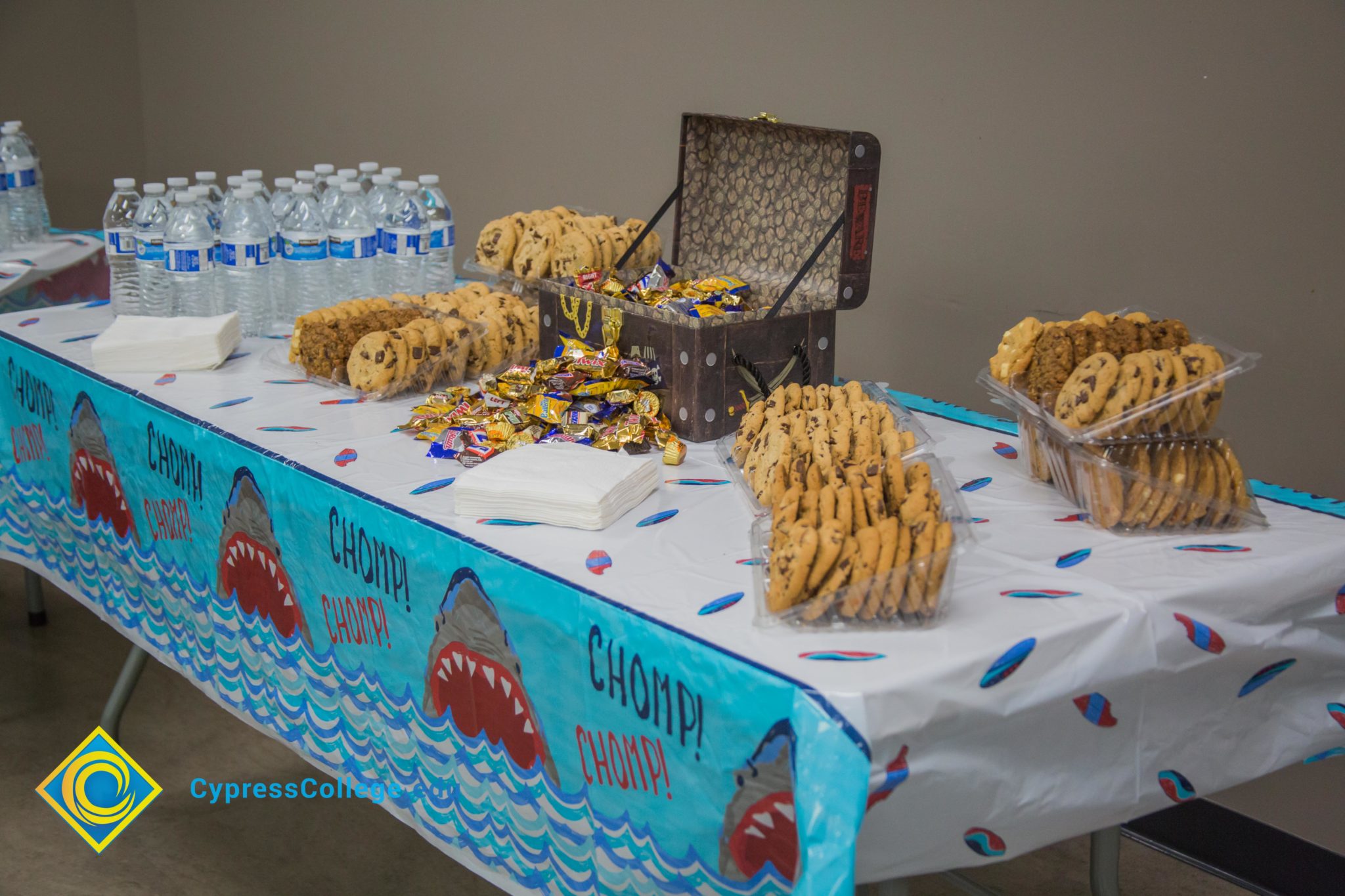 Dessert table with cookies and water.