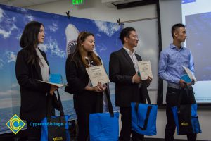 Four students holding award certificates.