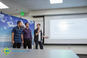 Three young men giving a presentation.