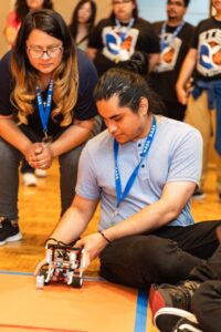Students set a robotic rover in place as part of a NASA competition