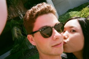 Students kiss on cheek in selfie. Photo taken for Disposable Camera Project.