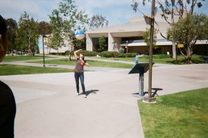Student plays with beach ball on campus. Photo taken for Disposable Camera Project.