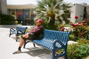 Student sits on bench in Gateway Plaza. Photo taken for Disposable Camera Project.