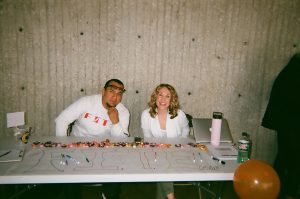 Student services workers at table. Photo taken for Disposable Camera Project.