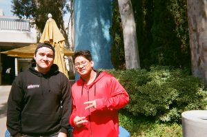 Students pose for photo in front of blue tile wall. Photo taken for Disposable Camera Project.