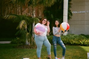 Students pose for selfie with multiple beach balls. Photo taken for Disposable Camera Project.