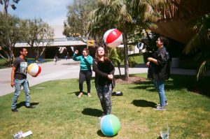 Students pose for picture with multiple beach balls. Photo taken for Disposable Camera Project.