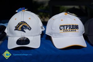Cypress College hats on a table.