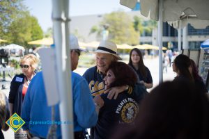 A gentleman with a hat embracing Dr. Mosqueda-Ponce.