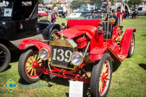 Red antique car on display with the 50th Anniversary Festival and Reunion.