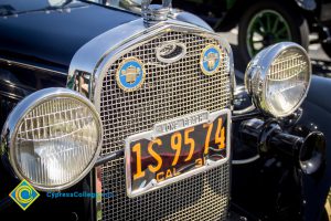 Front grille of a vintage Marc Touring vehicle with vintage black and yellow California license plate during the 50th Anniversary Festival and Reunion.