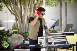 DJ with red headphone to his ear during the 50th Anniversary Festival and Reunion.