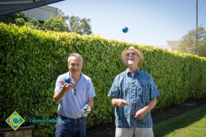 Two men juggling balls.