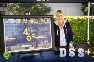 Celeste Phelps standing next to a large informational display at the DSS booth.