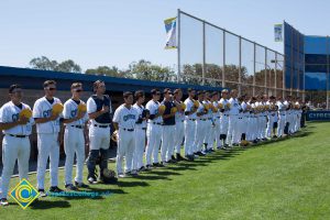 Cypress College baseball team standing with hats over hearts.