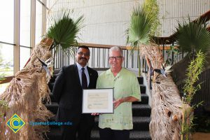 Santanu Bandyopadhyay and President Bob Simpson holding an award.