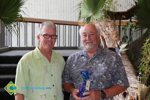 President Bob Simpson and a man in a grey and white shirt.