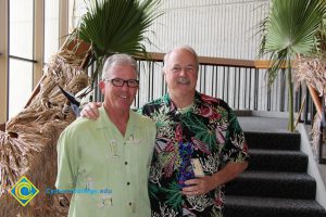 President Bob Simpson and a man in a Hawaiian shirt.
