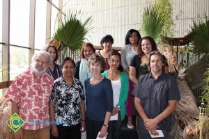 A group of staff smiling at the End of the Year Luau.