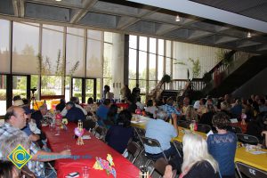 Staff seated at the End of the Year Luau.